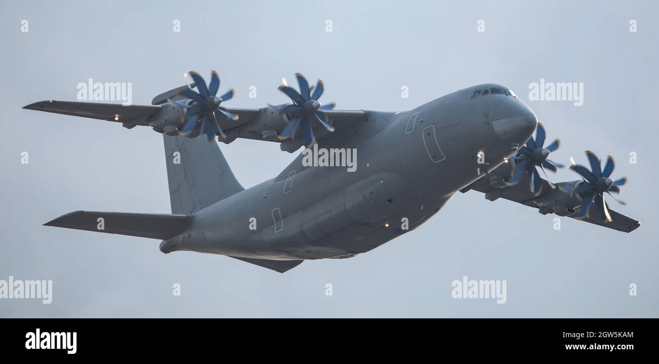 A twinengine military transport aircraft performs a flight Stock Photo