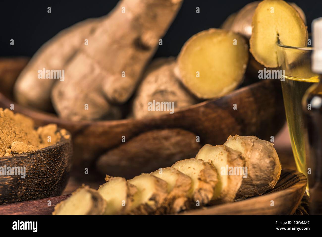 Sliced Ginger Root And Ginger Powder In The Bowl On The Table. Anti-inflammatory Herbal Medicine Stock Photo