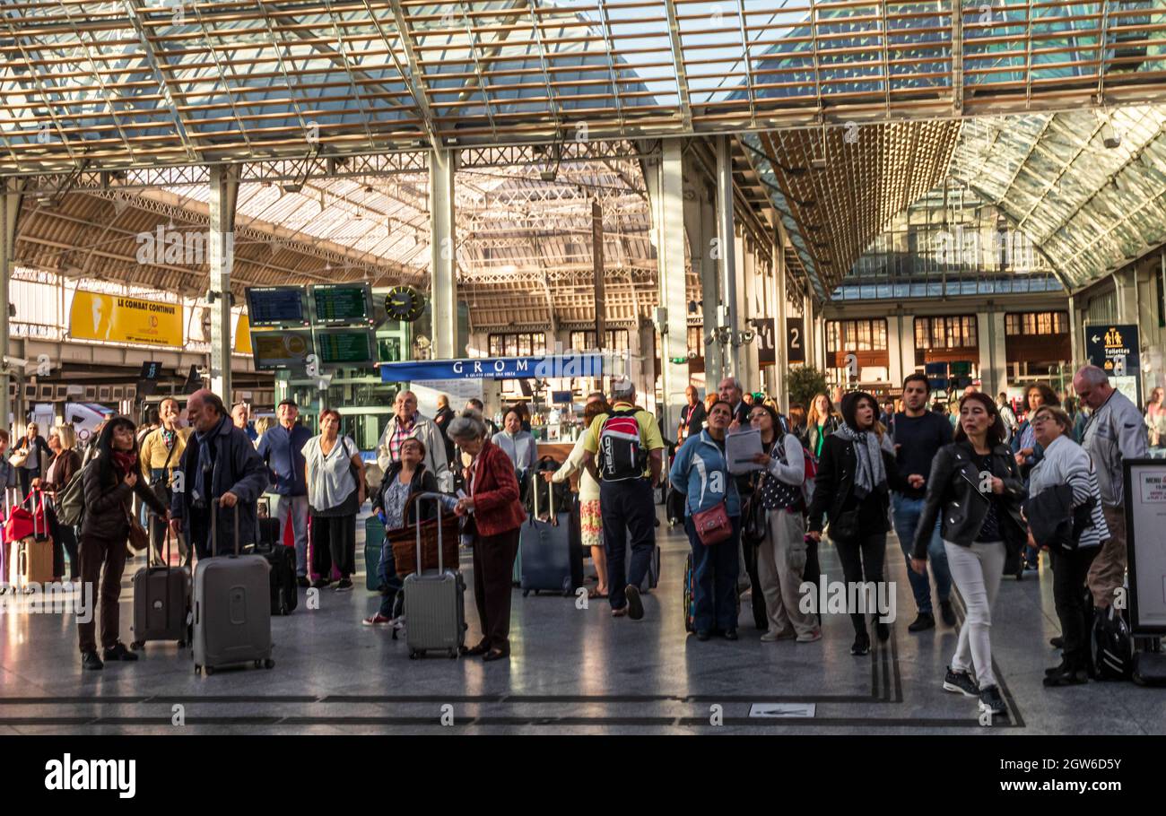 Crowds of people looking up toward the schedules in the Gare de Lyon railway station in Paris, France. Stock Photo