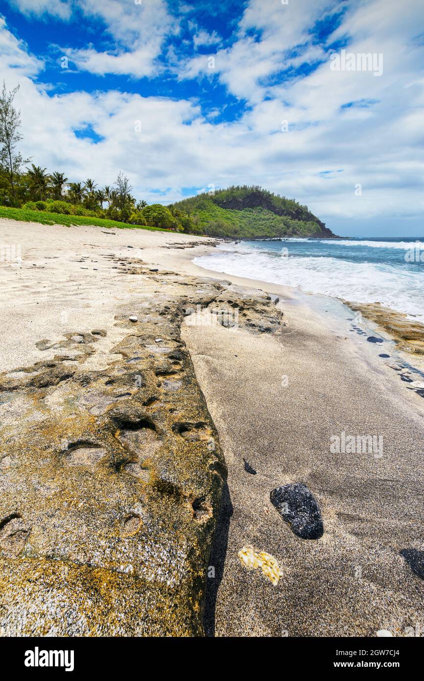 Sunny day with rocks, waves and sand at Grande Anse Beach, Reunion Island Stock Photo Alamy