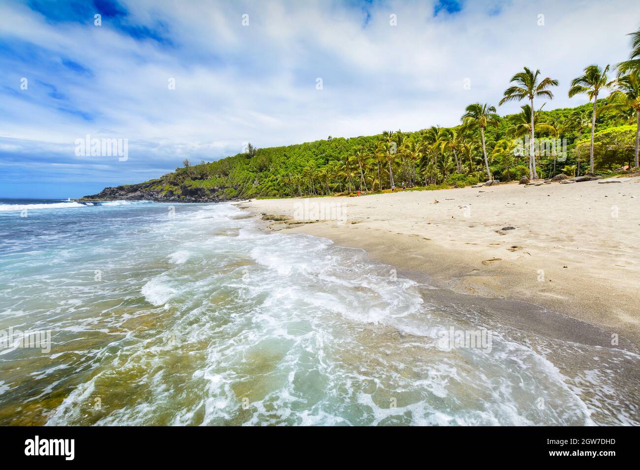 Sunny day with rocks, waves and sand at Grande Anse Beach, Reunion Island Stock Photo Alamy