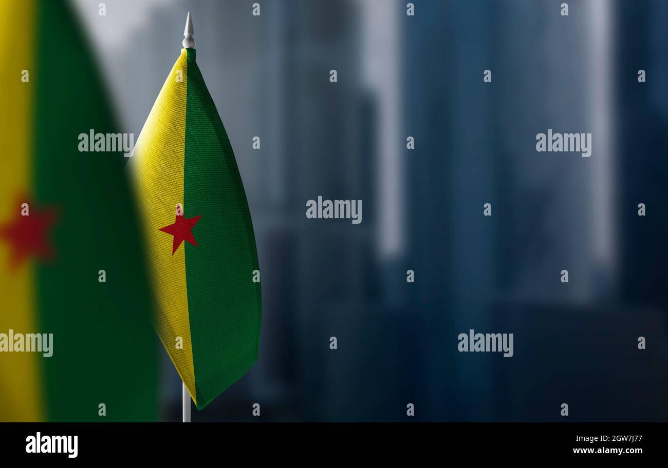 Small flags of French Guiana on a blurry background of the city Stock Photo
