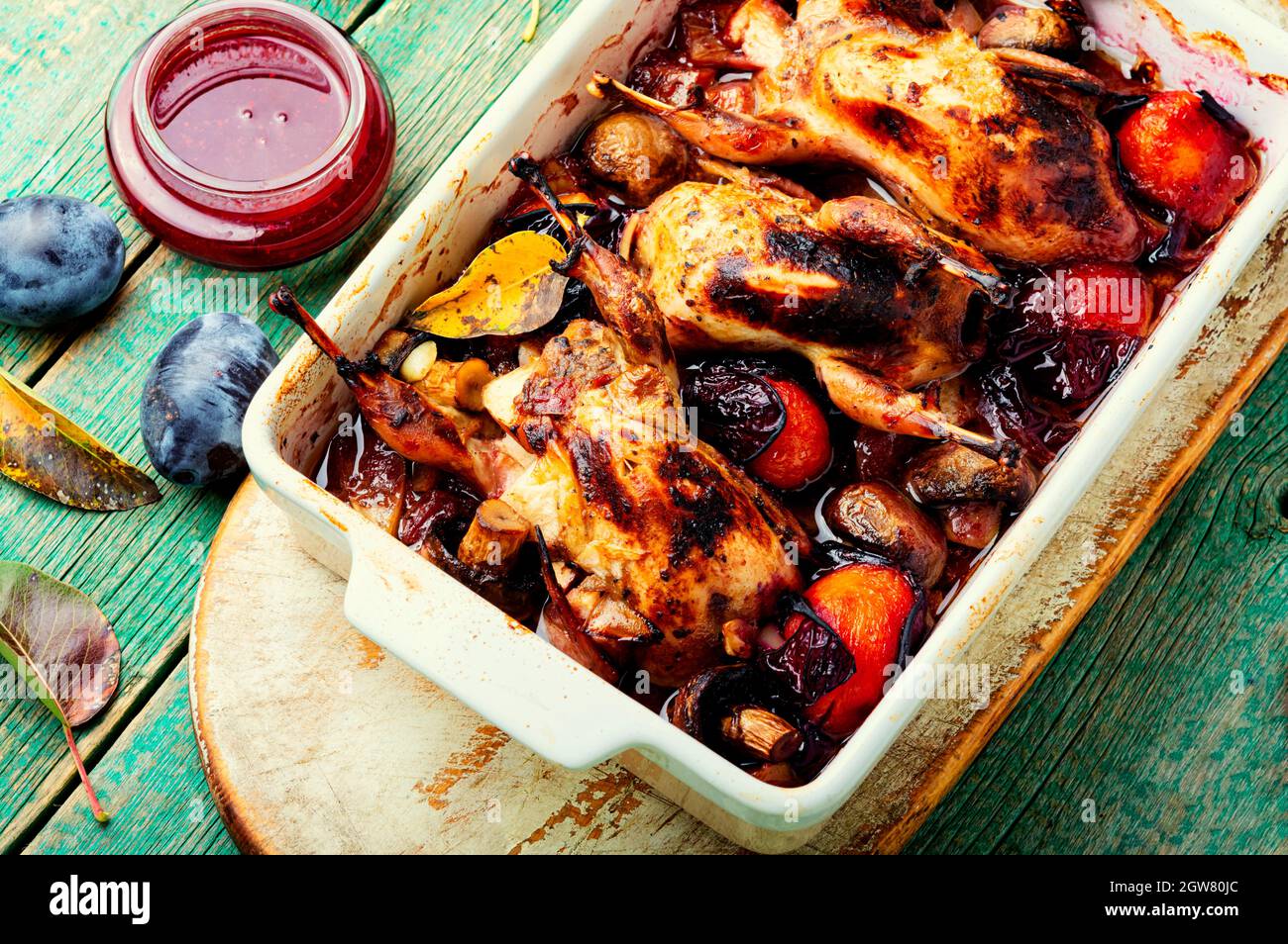 Roasted whole quail in plum sauce. Meat quail stuffed with plum Stock ...