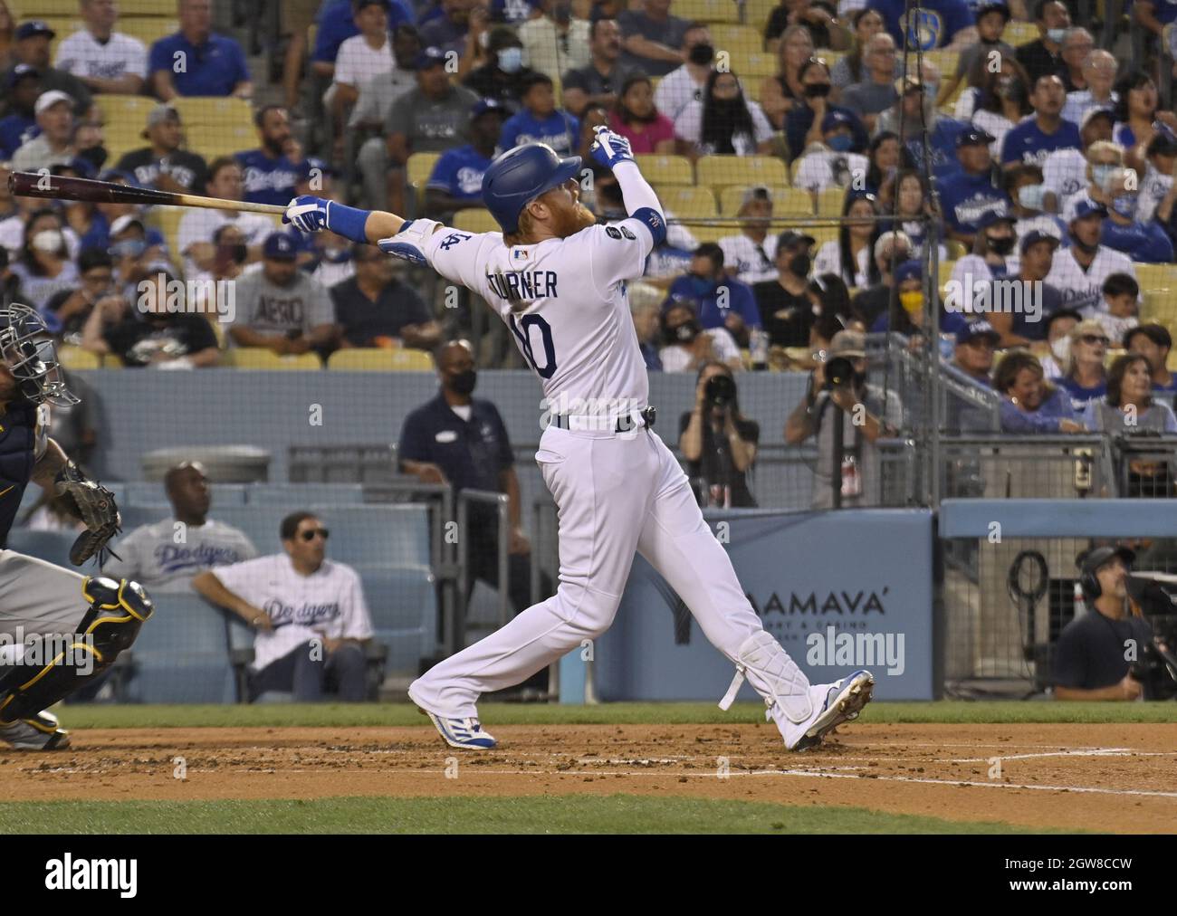 Los Angeles, United States. 03rd Oct, 2021. Los Angeles Dodgers' Justin Turner smashes three-run home run off Milwaukee Brewers' starting pitcher Corbin Burnes, a leading Cy Young Award candidate, to snatch a lead they wouldn't relinquish during the first inning at Dodger Stadium in Los Angeles on Saturday, October 2, 2021. Credit: UPI/Alamy Live News Stock Photo