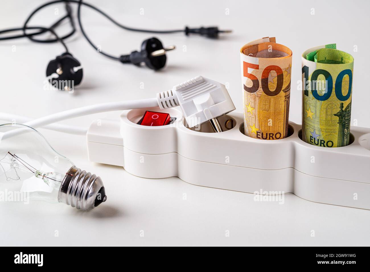 Fifty and one hundred euro banknotes plugged into the extension socket