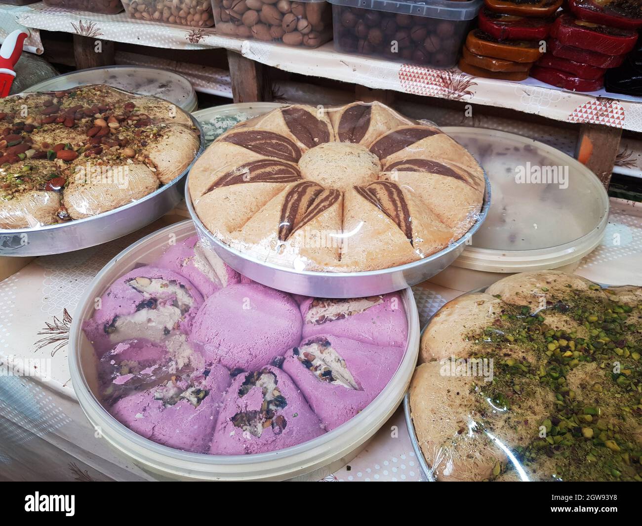 Round plate with sweet halva on the counter of an oriental bazaar. Stock Photo