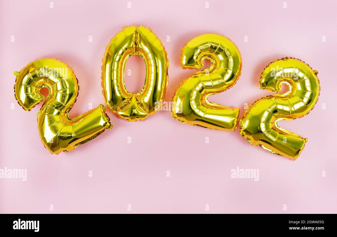 Happy New Year 2022. Numbers 2022 on pink background. Copy space. Stock Photo