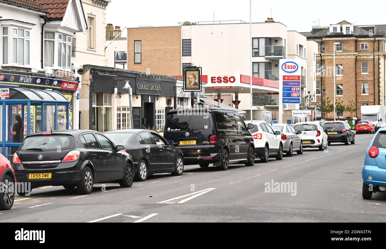 Worthing UK 3rd October 2021 -  Drivers queue to buy fuel at an Esso petrol station in Worthing this morning  : Credit Simon Dack / Alamy Live News Stock Photo