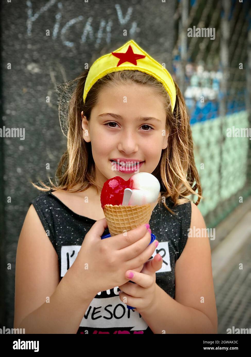 Portrait Of Girl Holding Ice Cream Outdoors Stock Photo