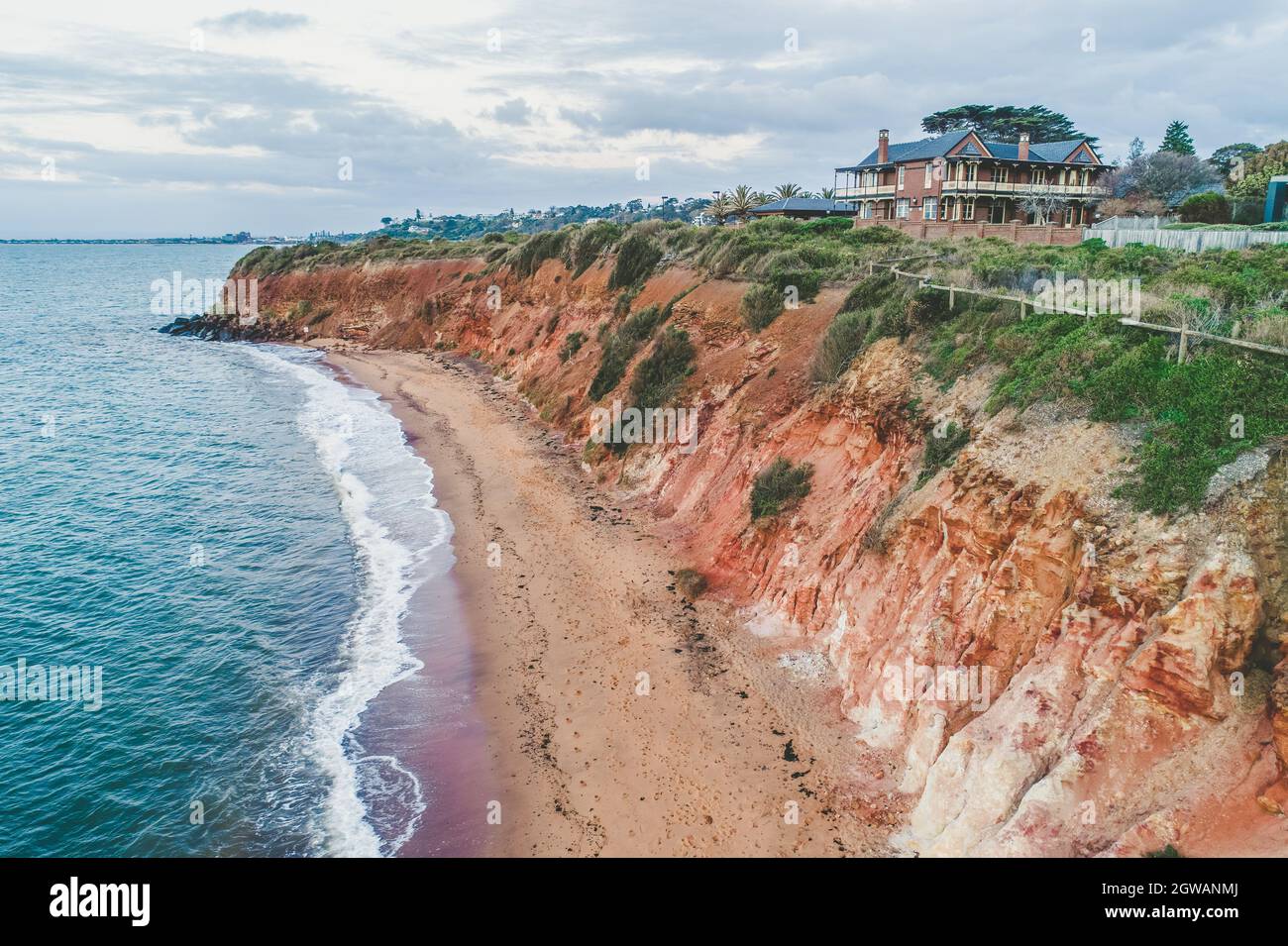 House On A Cliff Above Ocean In Australia - Aerial View Stock Photo