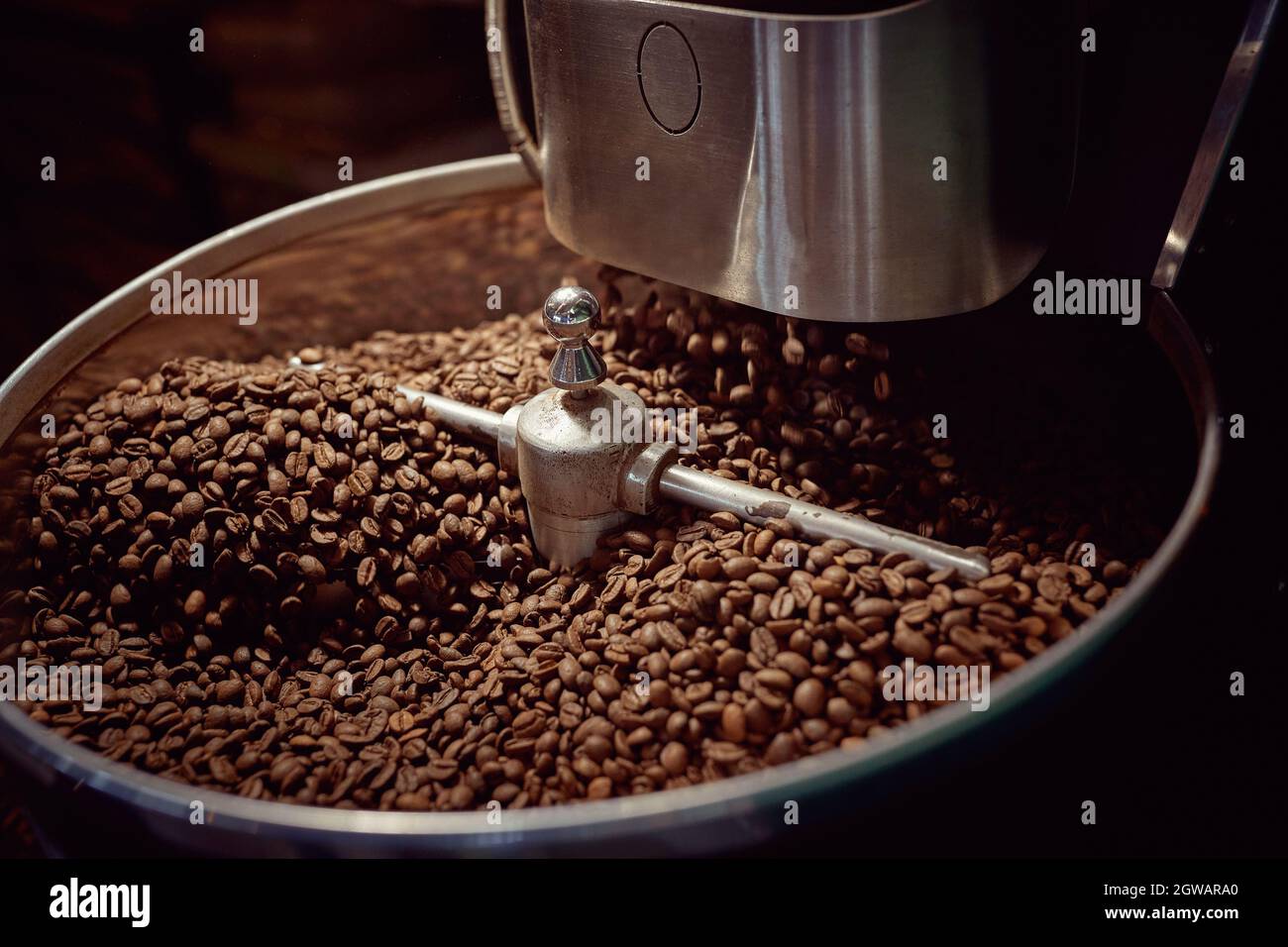 Roasting in machine.Coffee beans.Fresh coffee beans in roasting machine. Stock Photo