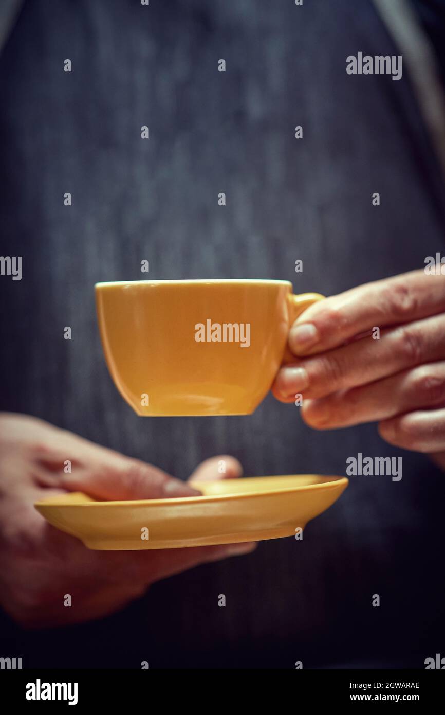 mug of delicious fresh coffee in hand Stock Photo