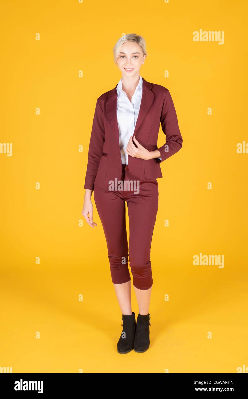 Portrait Of Businesswoman Against Yellow Background Stock Photo