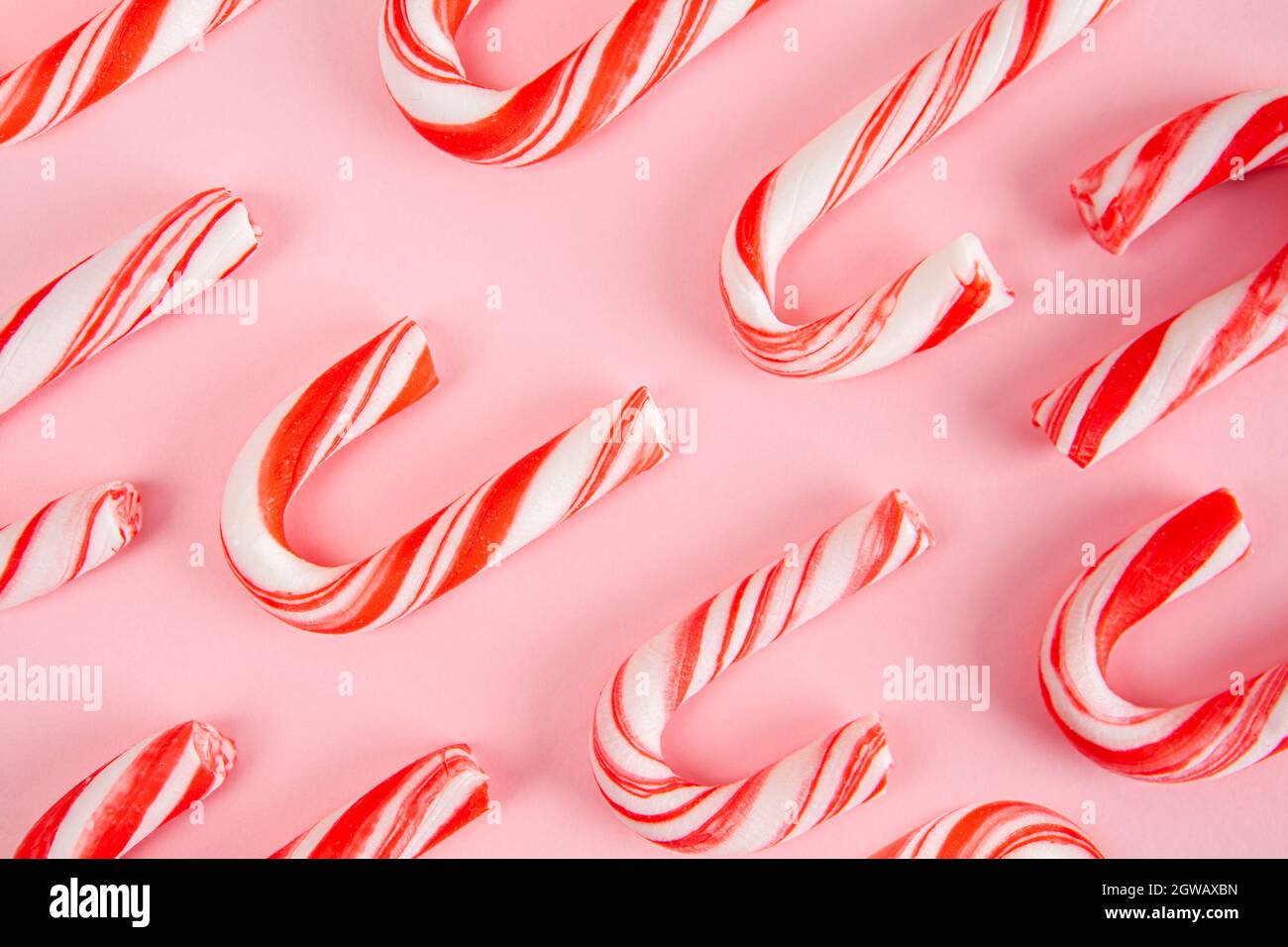 Christmas Candy Canes On Pink Background Pattern Stock Photo