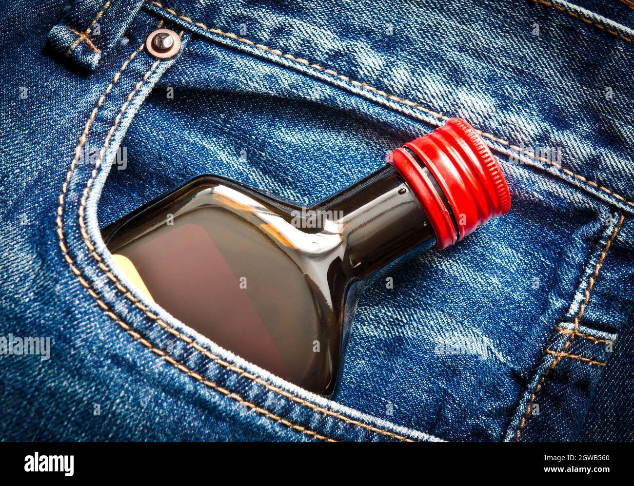 High Angle View Of Bottle In Jeans Pocket Stock Photo
