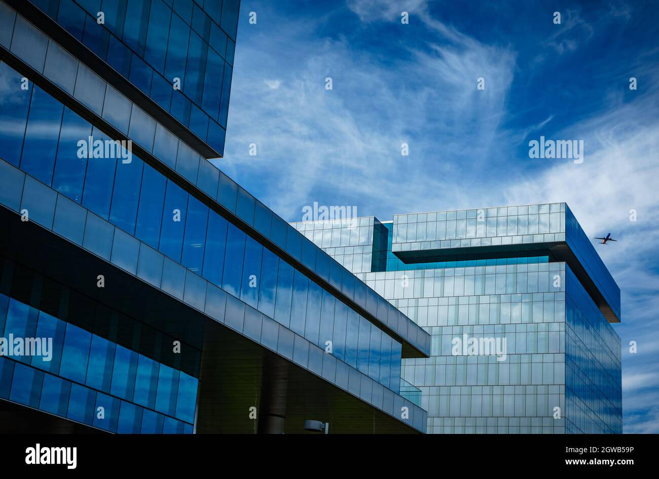 Low Angle View Of Modern Building Against Blue Sky Stock Photo