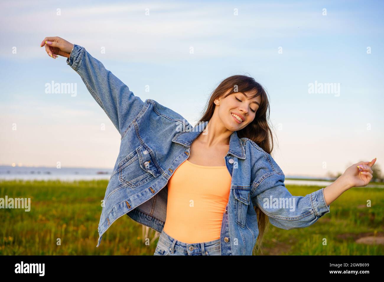 Woman dancing beach jeans hi-res stock photography and images - Alamy