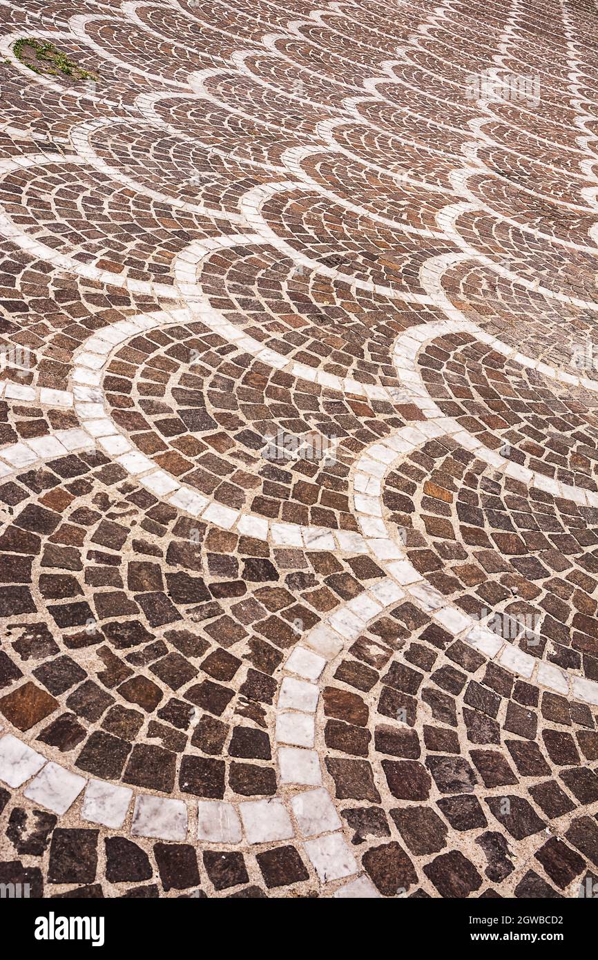 Classic pavement of an ancient Italian city, square stones mounted in