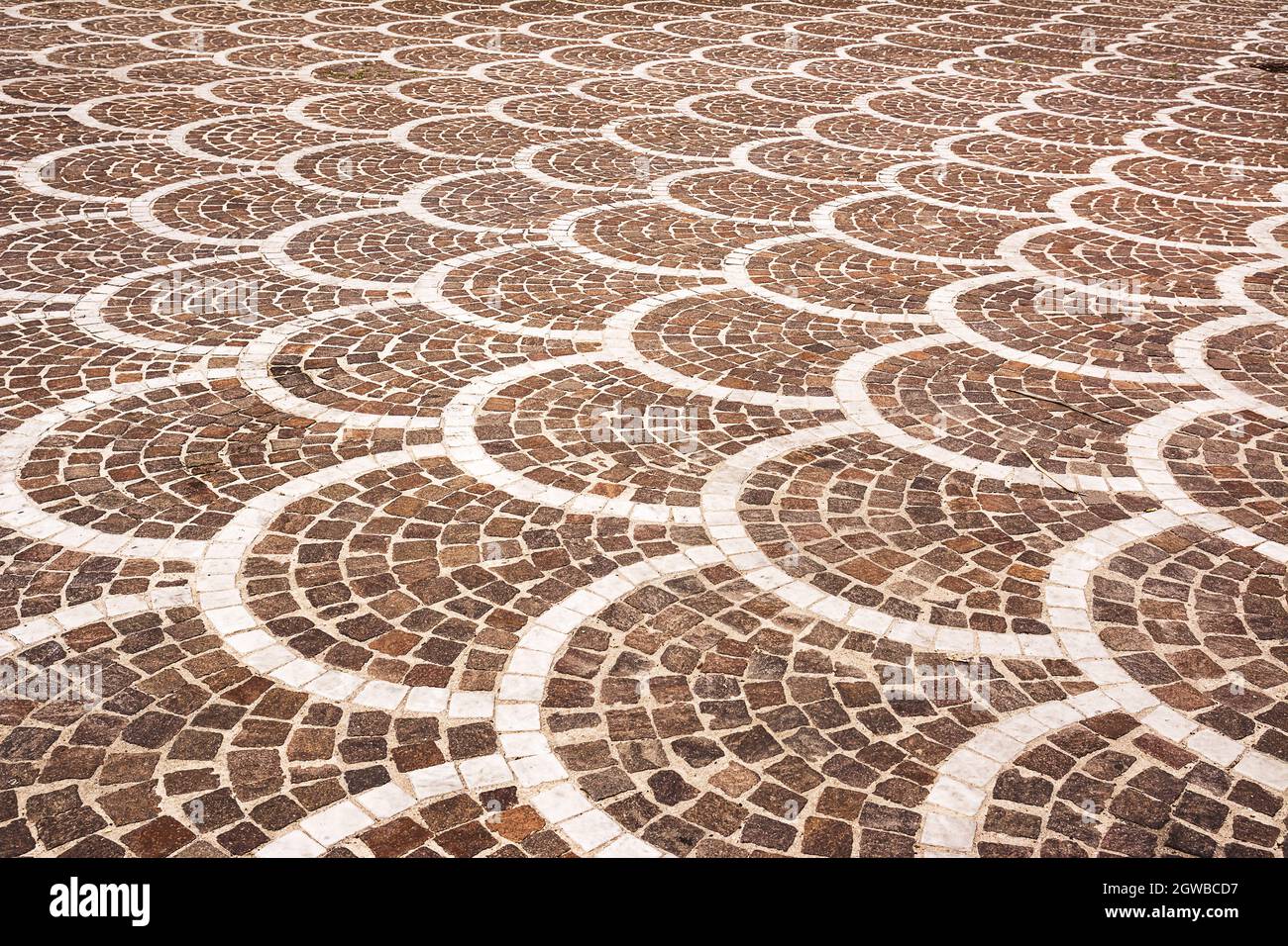 Classic pavement of an ancient Italian city, square stones mounted in