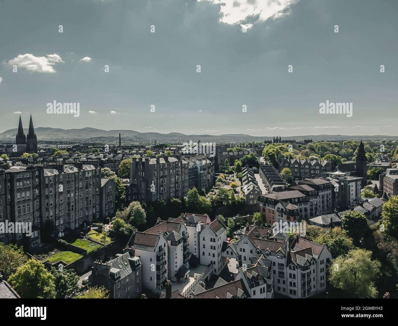 High Angle View Of City Buildings Against Cloudy Sky Stock Photo