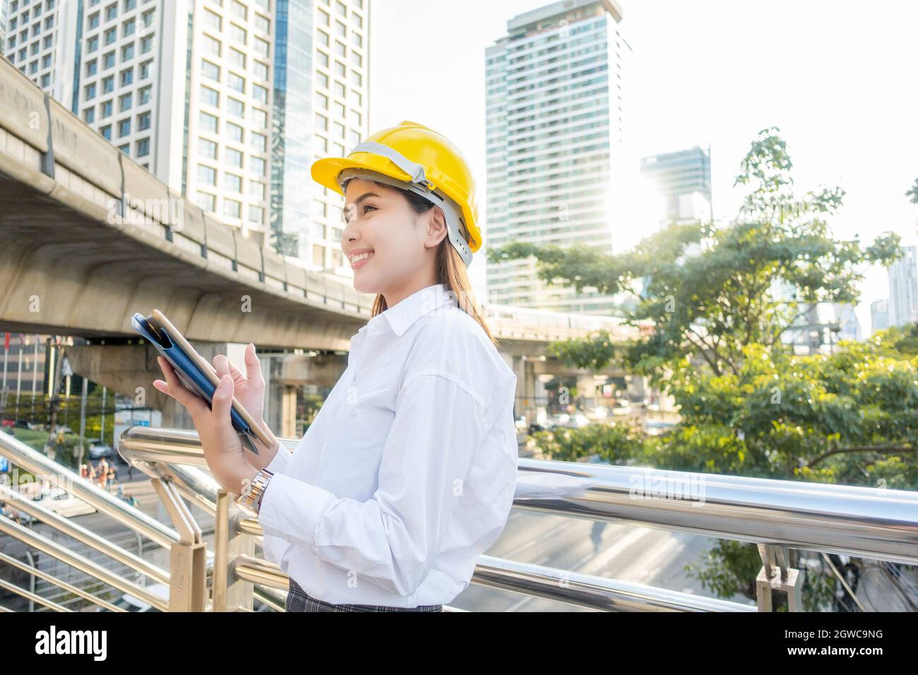 Architect Holding Digital Tablet While Standing By Railing In City Stock Photo