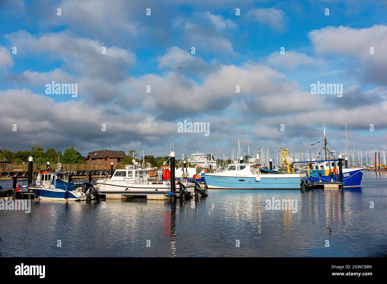 The Isle of Wight Ferry and fishing boats in Lymington Harbour, Hampshire, England Stock Photo