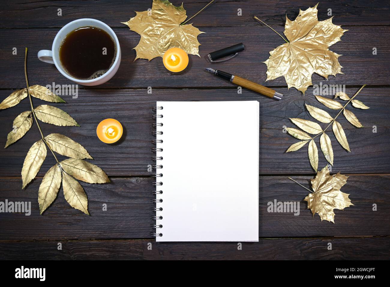 mock up of a blank notebook page on a dark rustic wooden table with ...