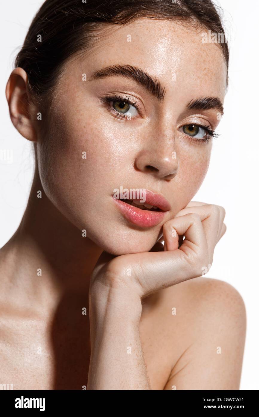 Attractive female model with natural makeup, glowing healthy skin after