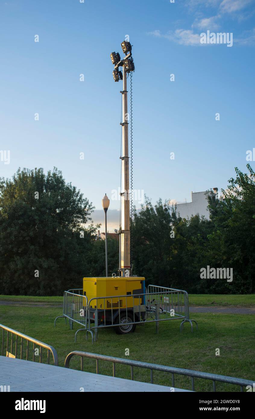 Moble fuel consumption light tower over grass during daylight performance. Sunset blue sky background Stock Photo