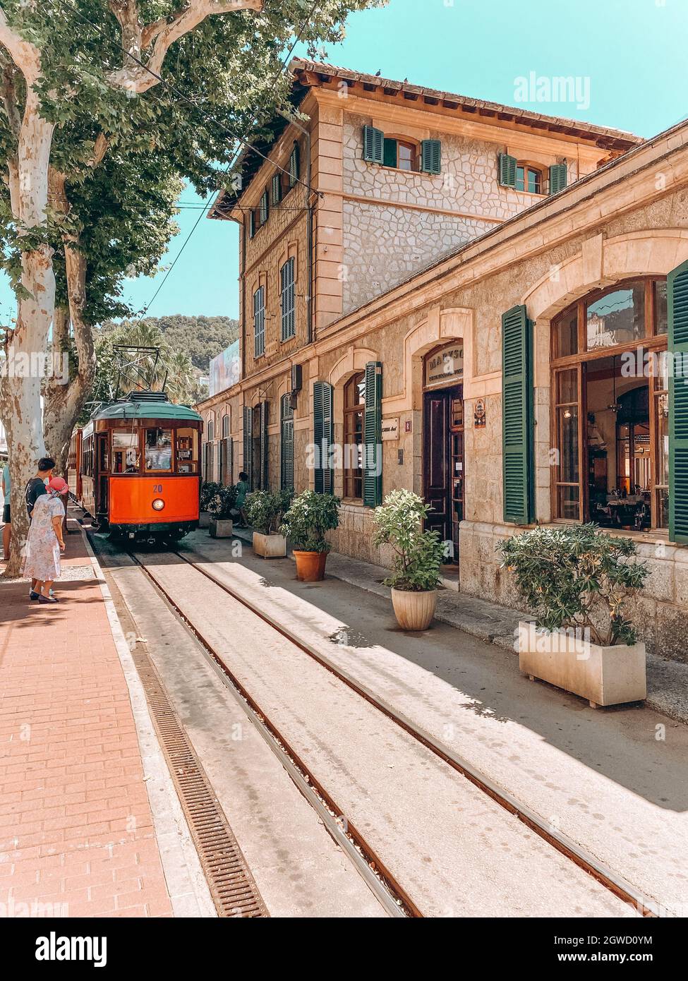 Couple waiting for the vintage streetcar by the station in Puerto de Soller Stock Photo