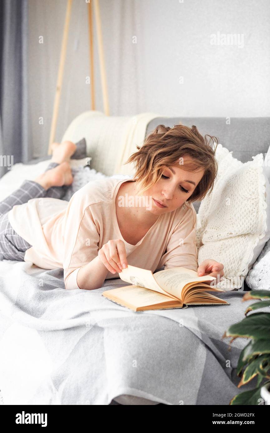 Young Woman Lying On Bed At Home Stock Photo Alamy