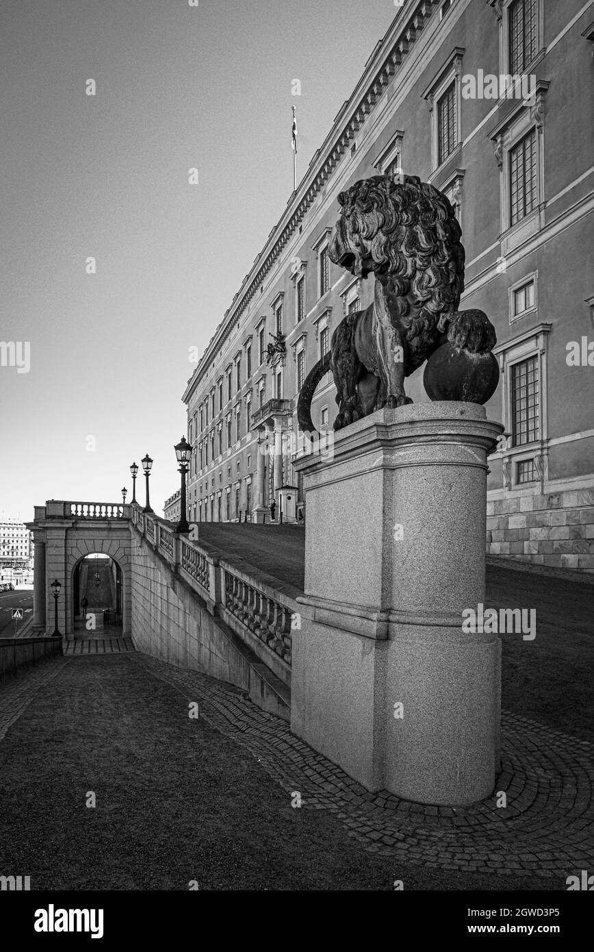 Brass lion and a single guard guarding the Swedish Royal Pallace Stock Photo