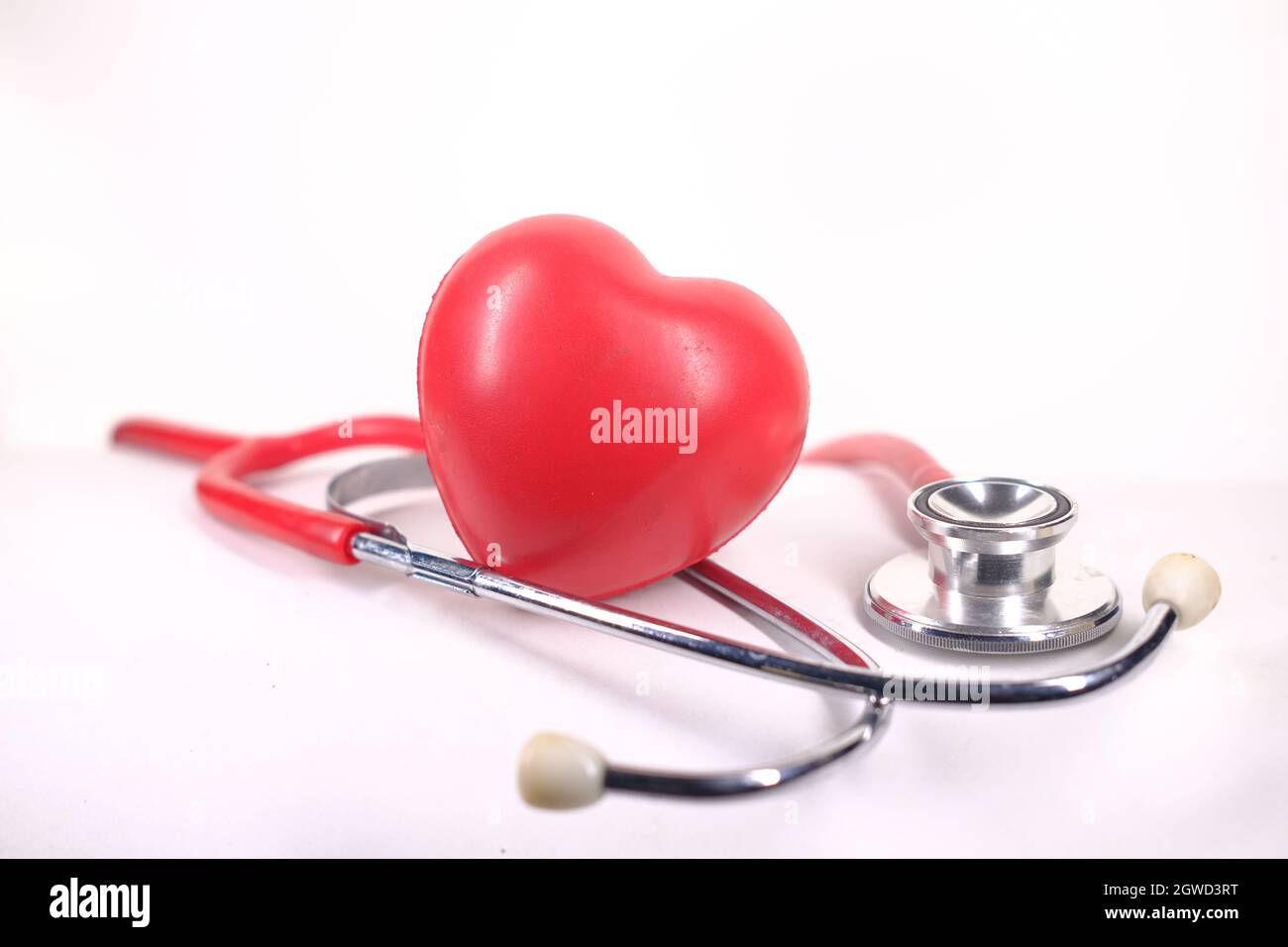 heart shape symbol and stethoscope on white background Stock Photo - Alamy