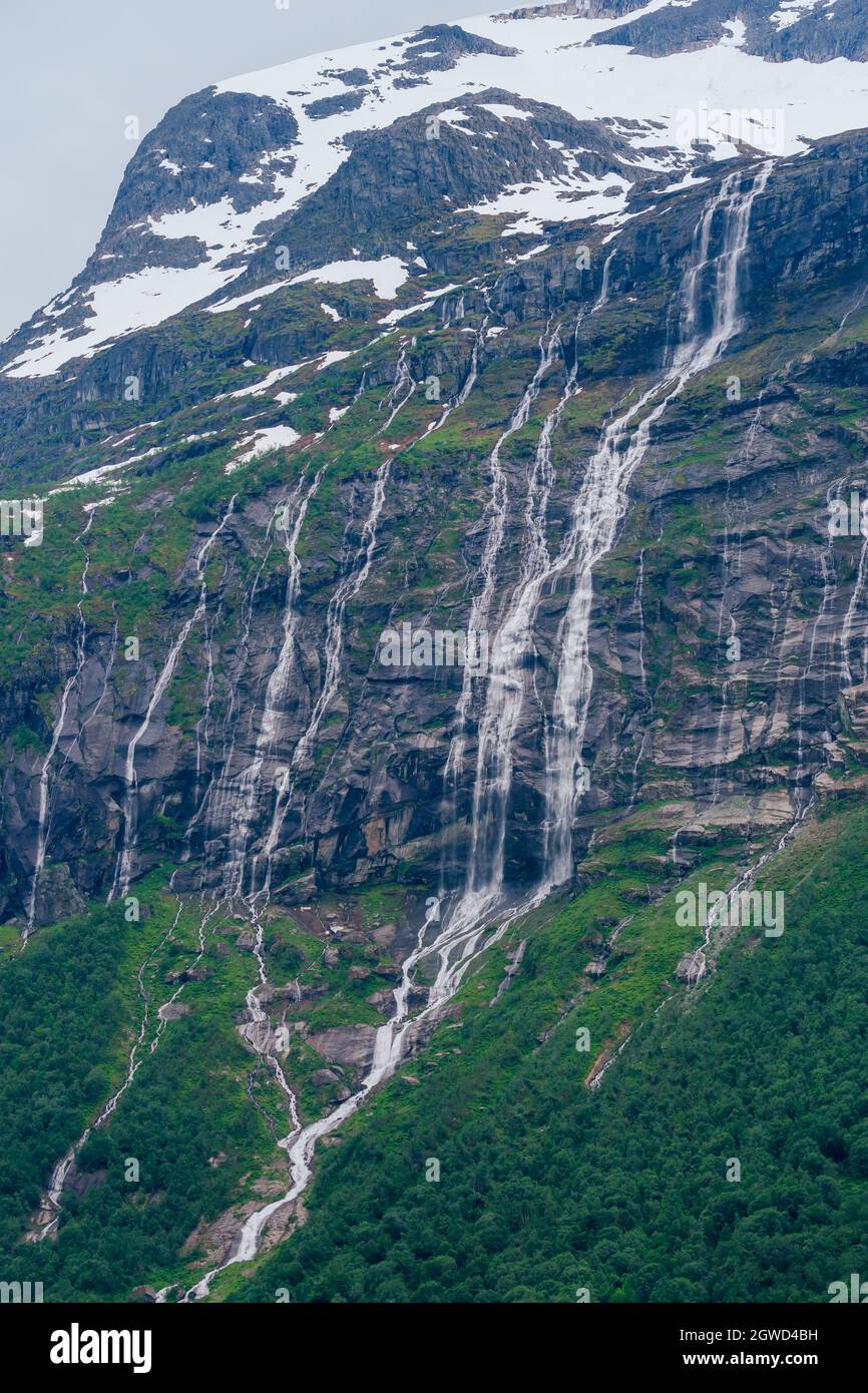 LOEN, NORWAY - 2020 JUNE 20. Springtime with ice water melting and makes alot of waterfalls on the mountain. Stock Photo