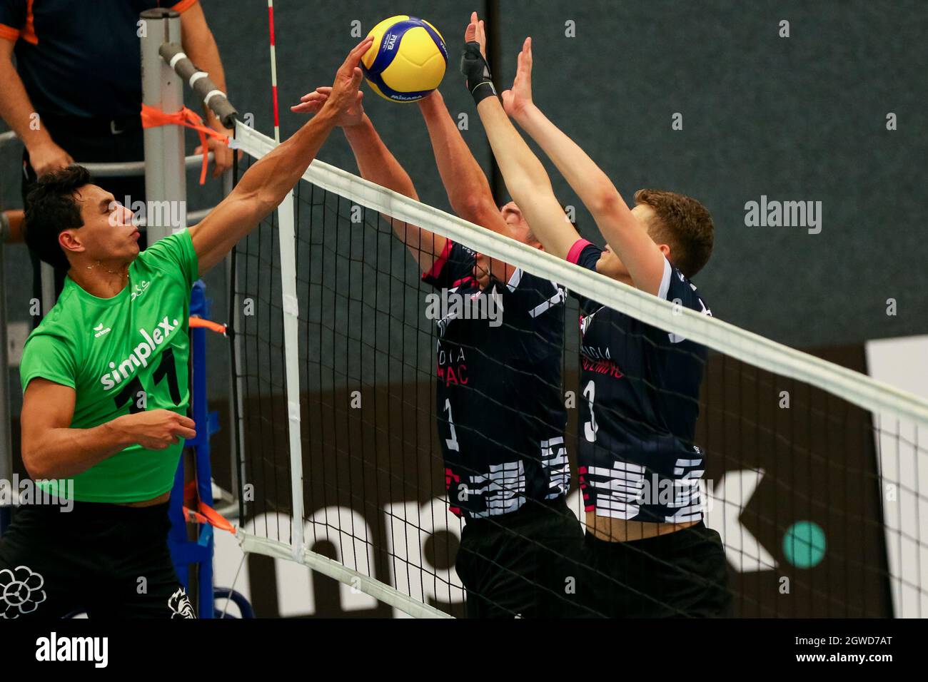 BARNEVELD, NETHERLANDS - OCTOBER 2: Cas Abraham of Simplex SSS, Nico  Freriks of Numidia TopVolleybal Limburg and Lennard Vossen of Numidia  TopVolleybal Limburg during the Eredivisie Volleybal match between Simplex  SSS and