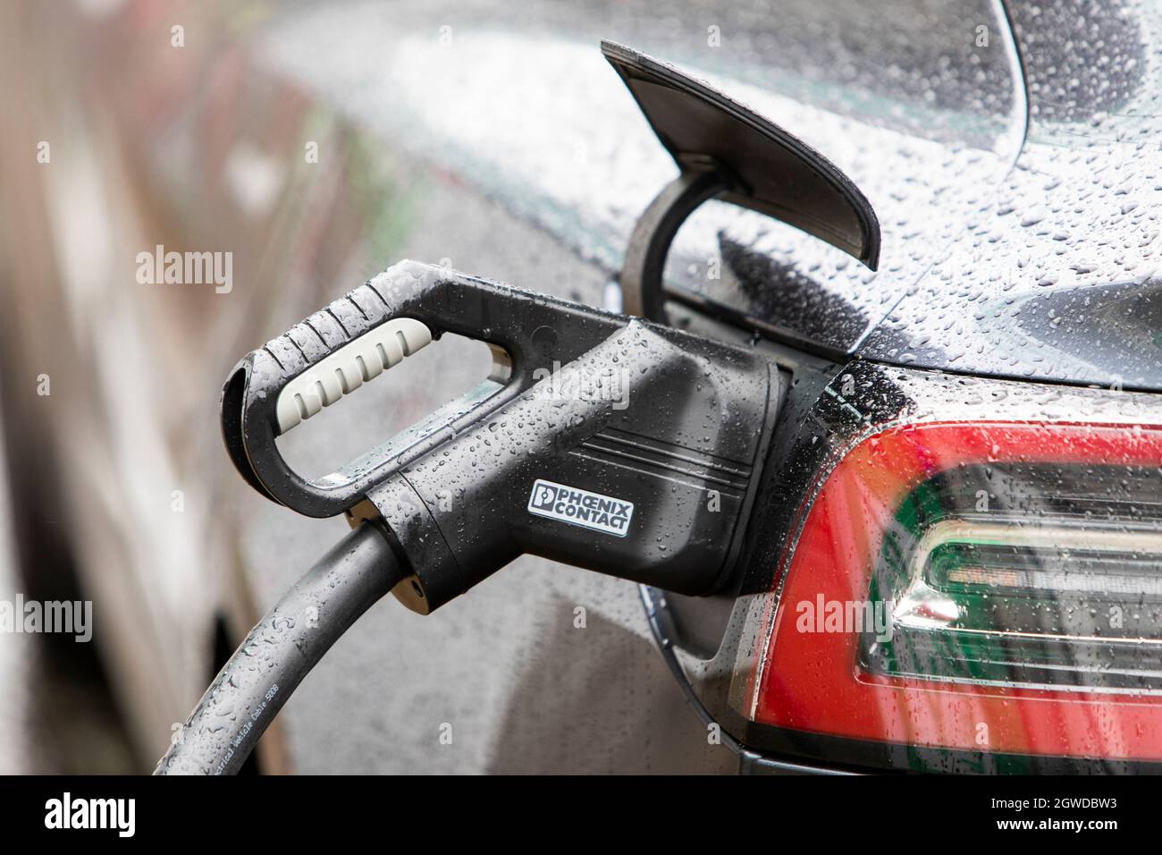 An Electric Vehicle recharging curbside in the centre of Manchester, UK. Stock Photo