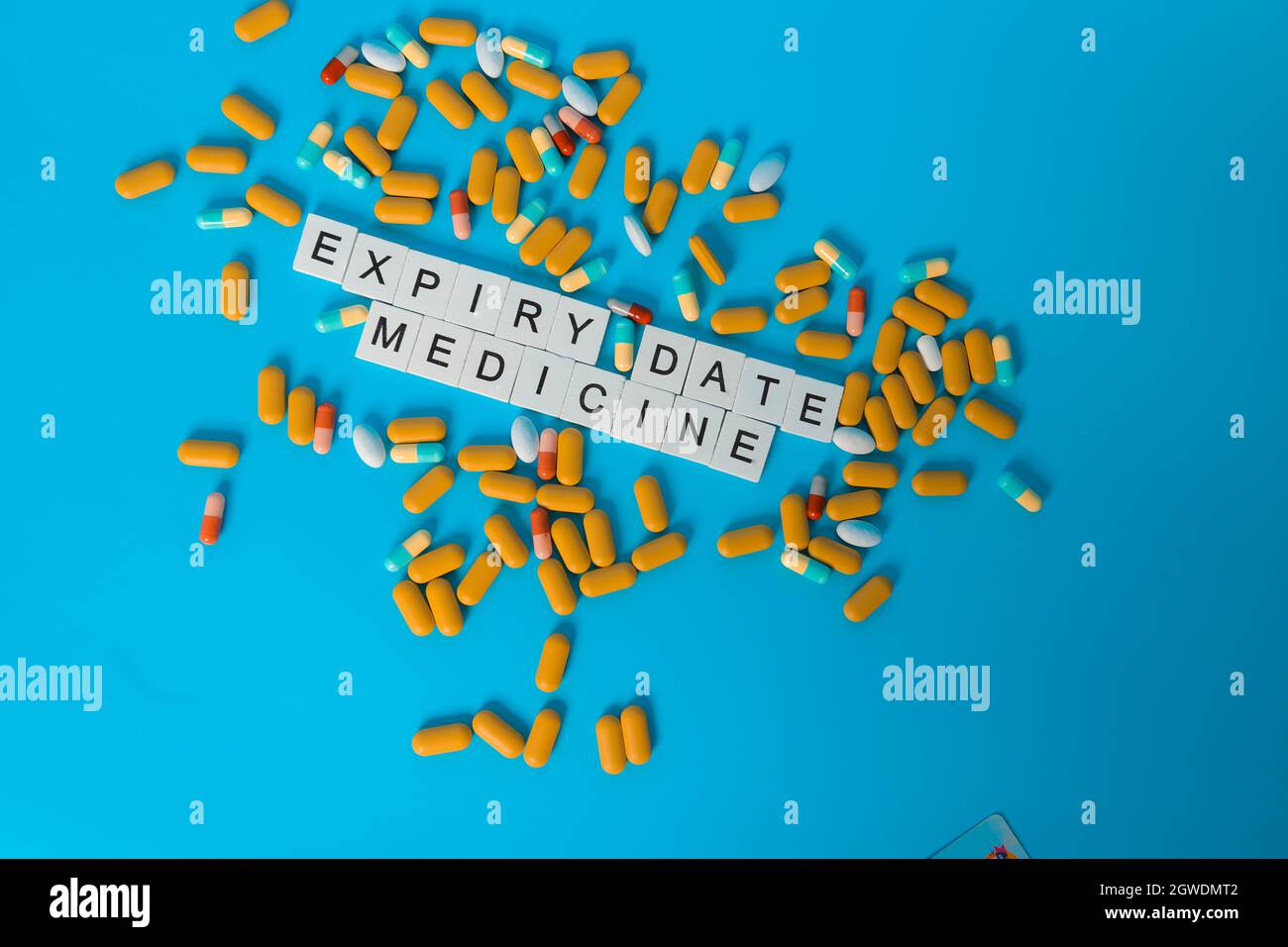 The Word Of Expiry Date Medicine With Pill On Blue Background