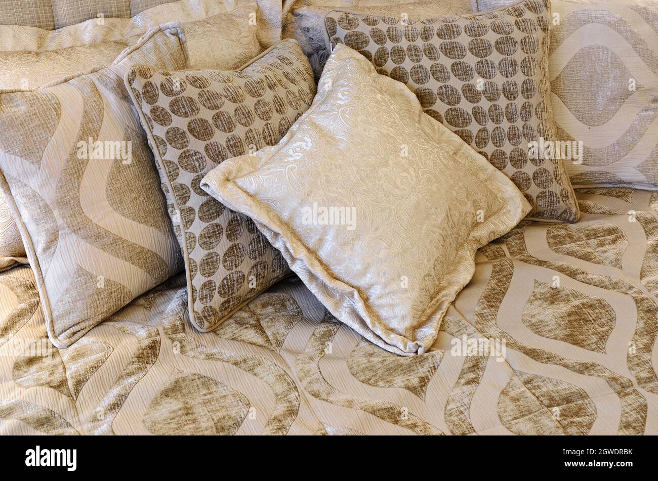 Beautiful pillows on a cozy bed. Ornamented soft plush fabric (velvet