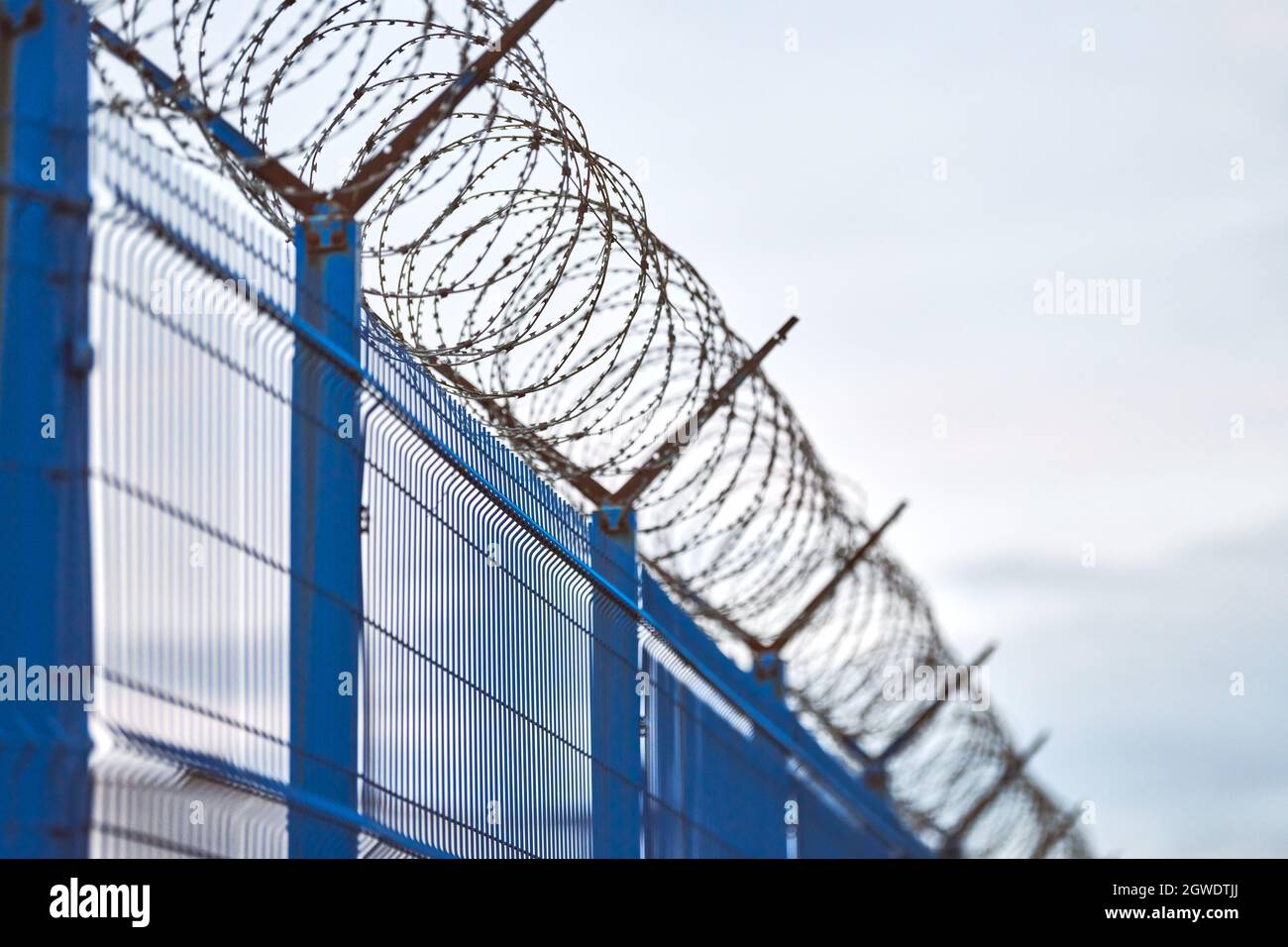 Low Angle View Of Barbed Wire On Fence Against Sky Stock Photo