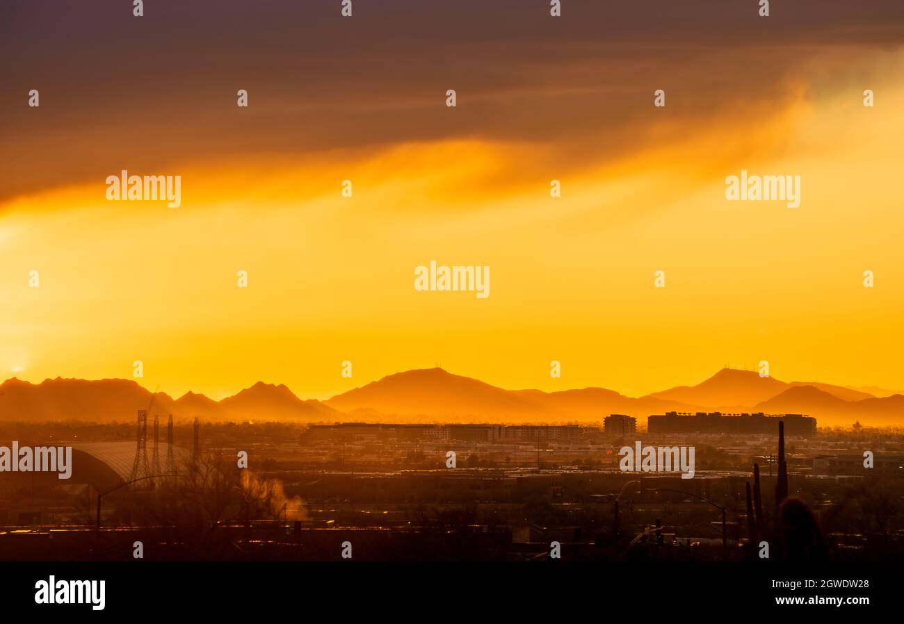 Scenic View Of Silhouette Mountains Against Orange Sky Stock Photo