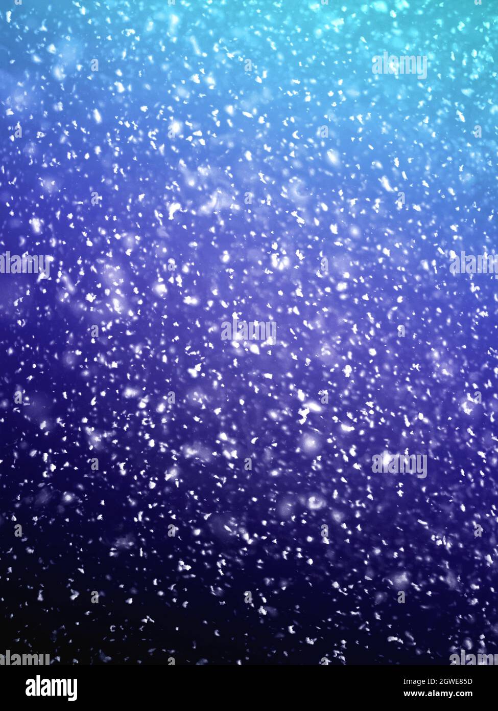 Falling snowflakes outside the window. Close-up. Winter background Stock Photo