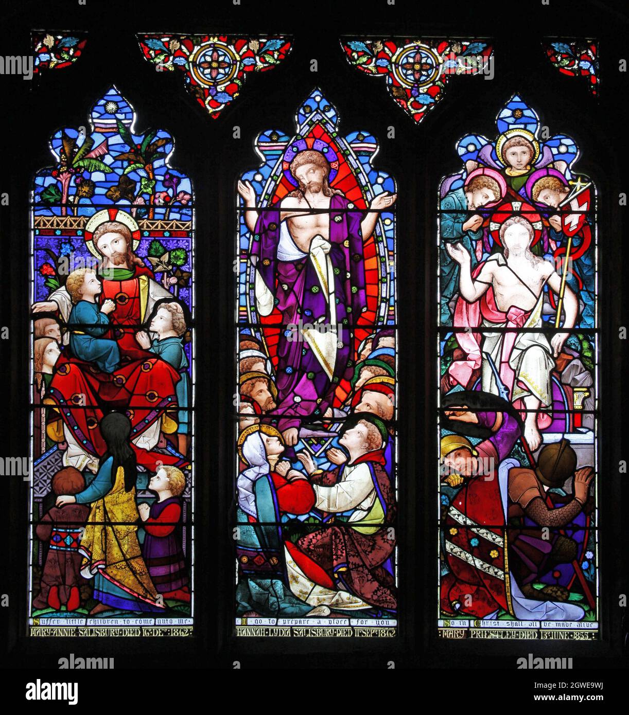 A stained glass window by Heaton Butler & Bayne depicting Jesus with Children, Ascension & Resurrection, St James Church, Newbottle, Northamptonshire Stock Photo