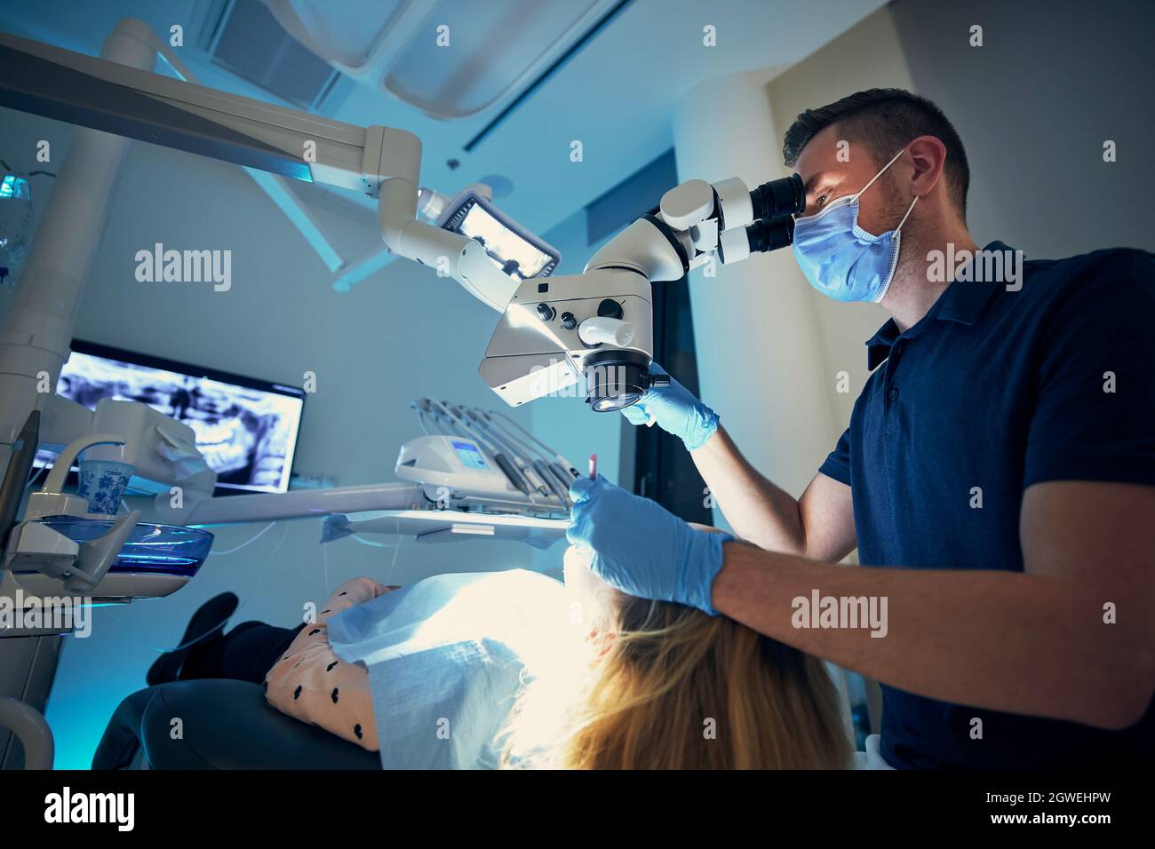 Dentist Wearing Mask Examining Girl At Clinic Stock Photo Alamy