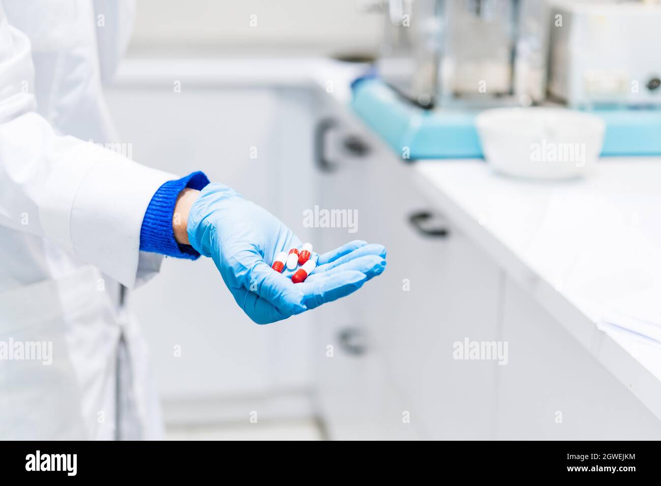 Midsection Of Scientist Holding Capsules At Laboratory Stock Photo