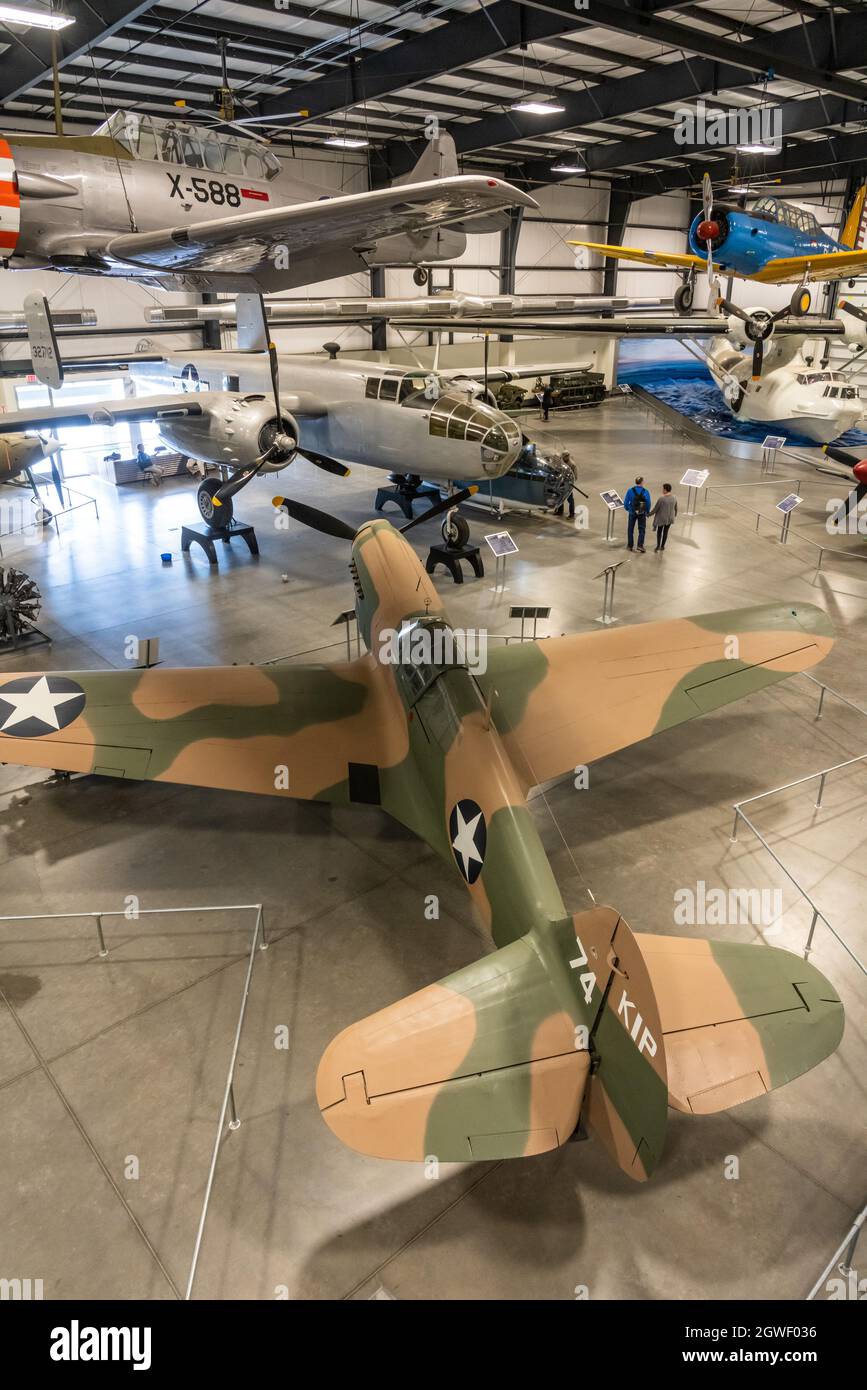 A Curtiss P-40E Warhawk U.S. Army Air Forces multi-role fighter in World War II.  Pima Air & Space Museum, Tucson, Arizona.  Also shown are   T-6 Texa Stock Photo