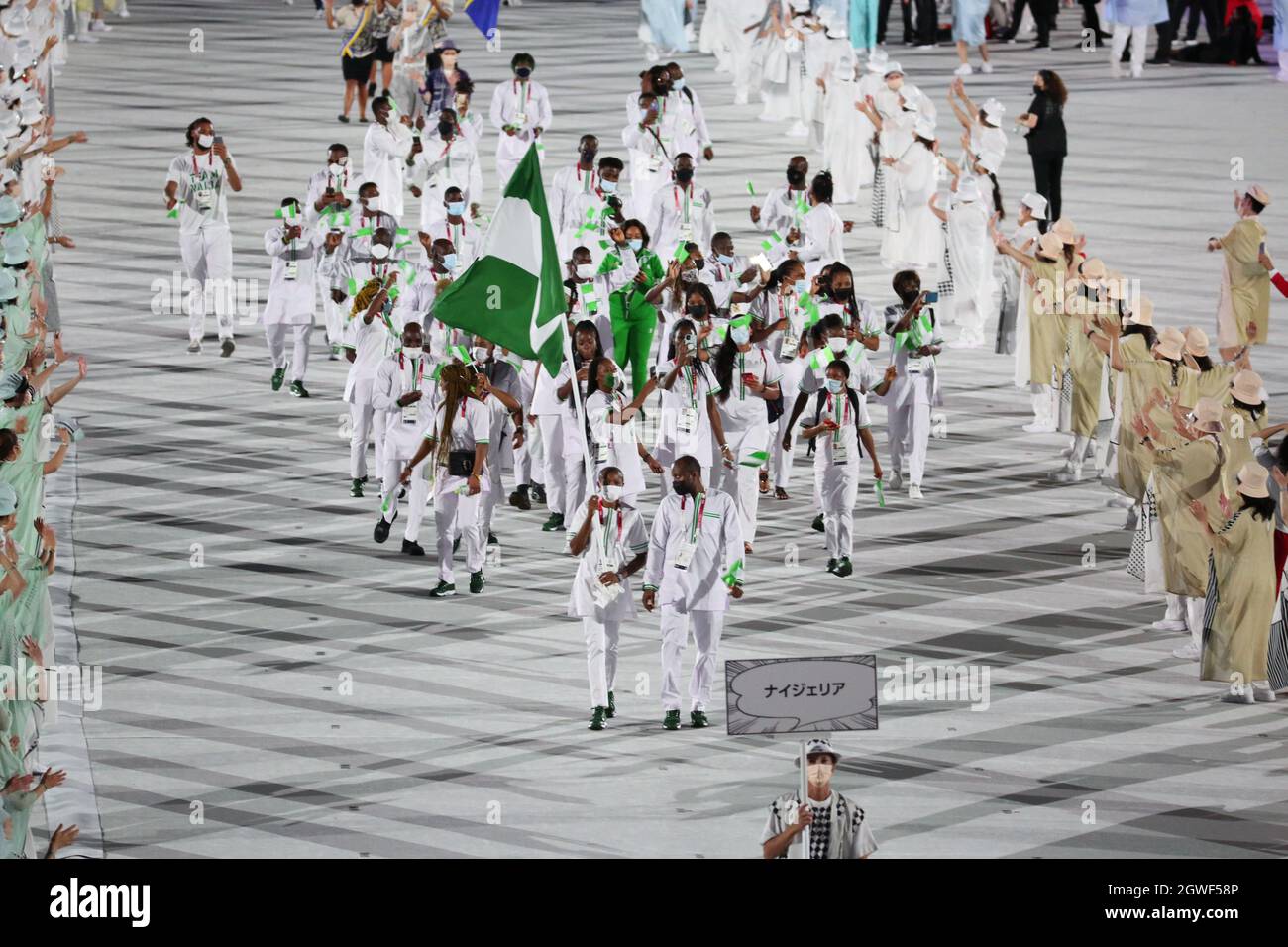 JULY 23rd, 2021 - TOKYO, JAPAN: Nigeria's flag bearers Odunayo Adekuoroye and Quadri Aruna enter the Olympic Stadium with their delegation during the Stock Photo