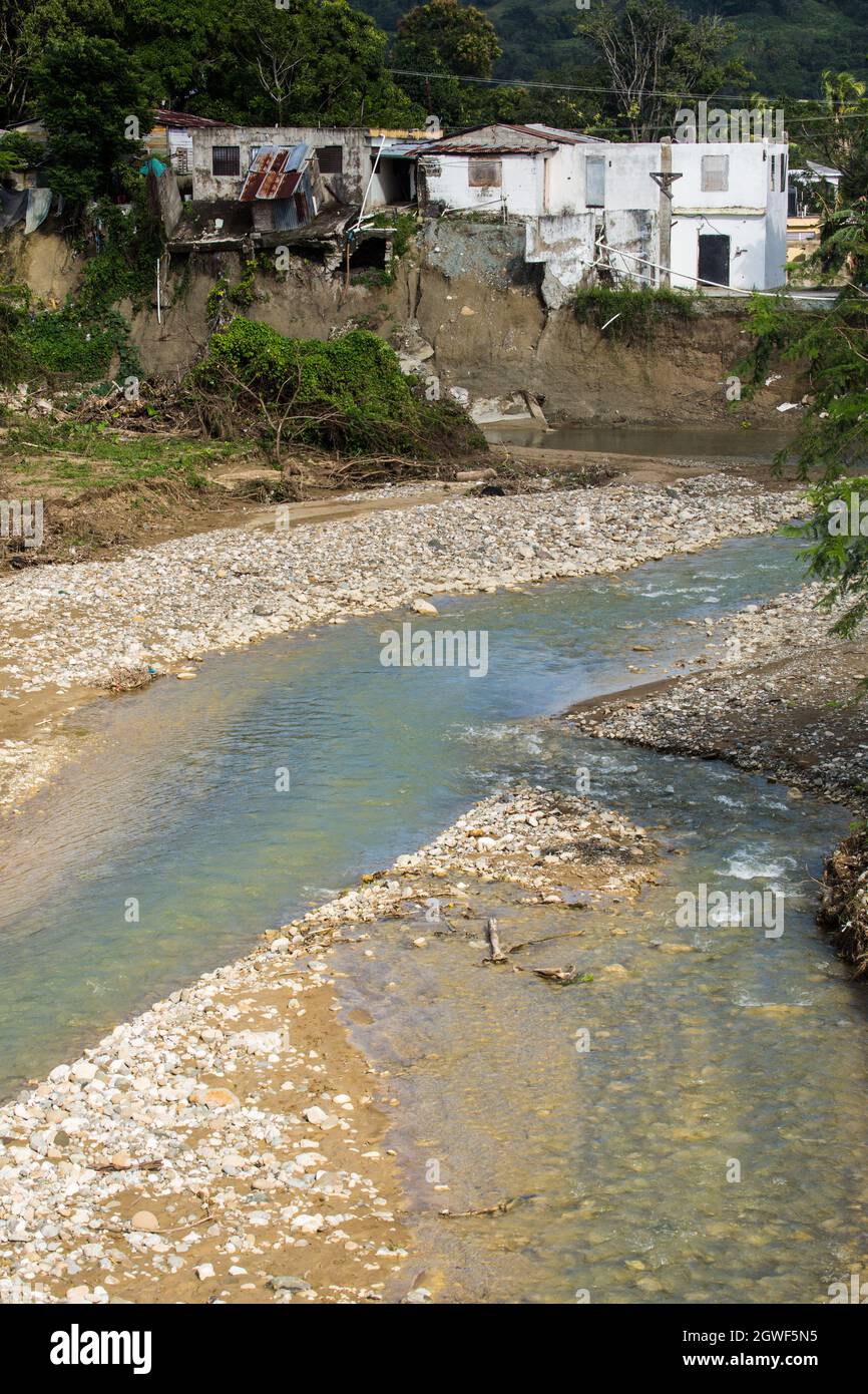 Houses severely damaged when the banks of the Bajabonico River were washed away in a flood. Barrio Espana, Imbert,  Dominican Republic. Stock Photo