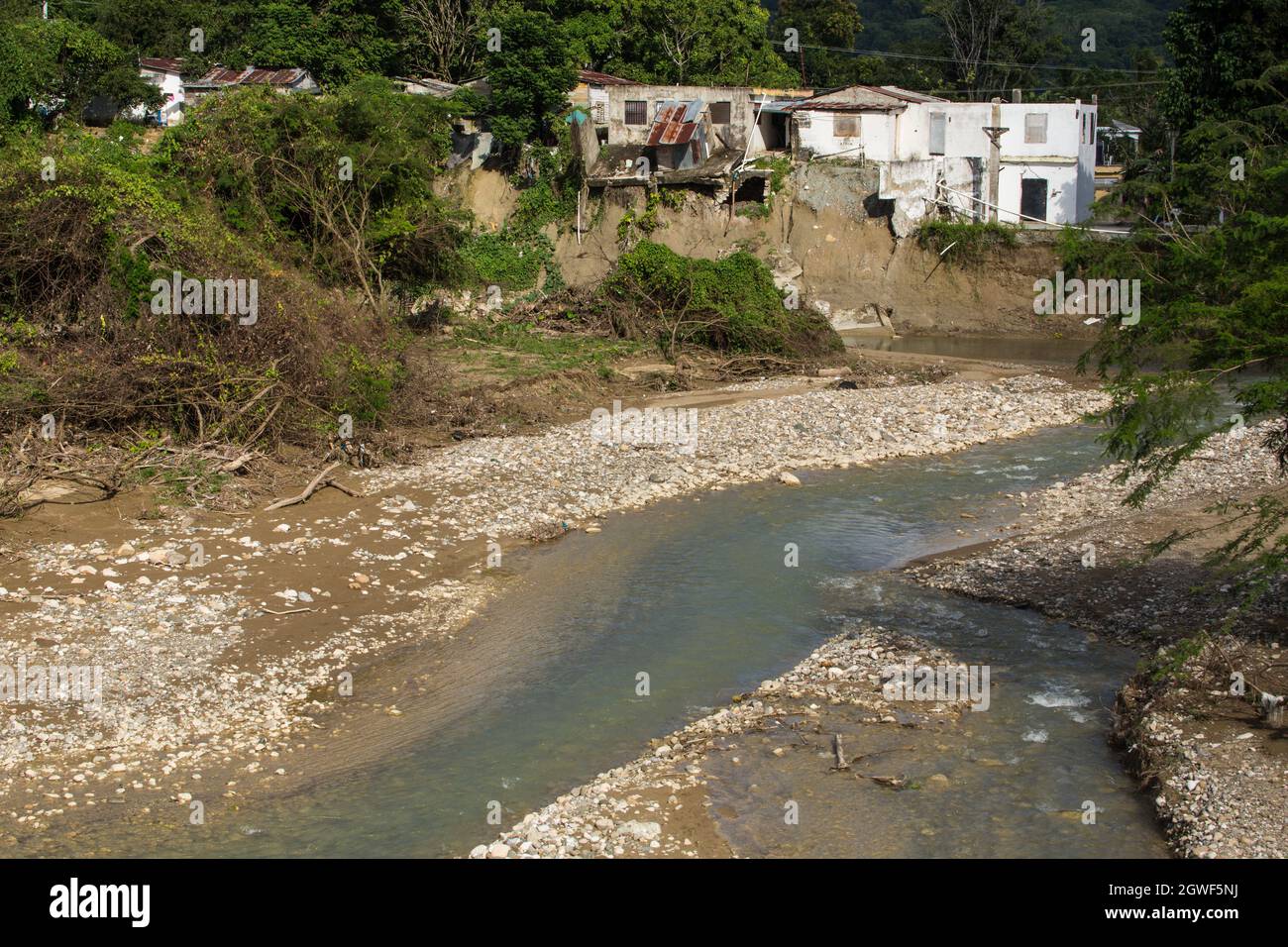 Houses severely damaged when the banks of the Bajabonico River were washed away in a flood. Barrio Espana, Imbert,  Dominican Republic. Stock Photo