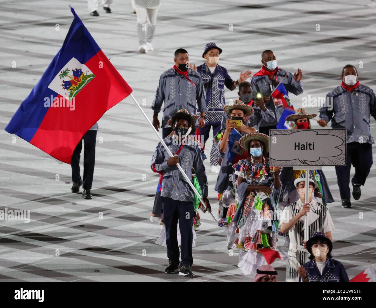 JULY 23rd, 2021 - TOKYO, JAPAN: Haiti's flag bearers Sabiana Anestor and Darrelle Valsaint enter the Olympic Stadium with their delegation during the Stock Photo