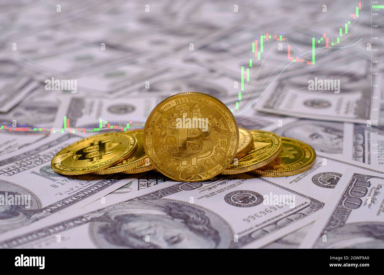 Gold bitcoin coins cryptocurrency on the group of money 100 USD dollars a  lot of Stock Photo - Alamy